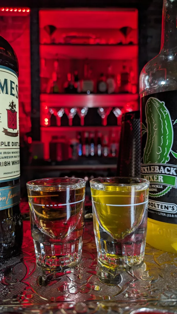A bottle of whiskey and a bottle of gin, perfect for mixing up cocktails at the bar.