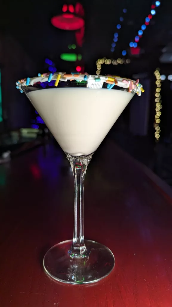 A martini with sprinkles on top, served at the bar.